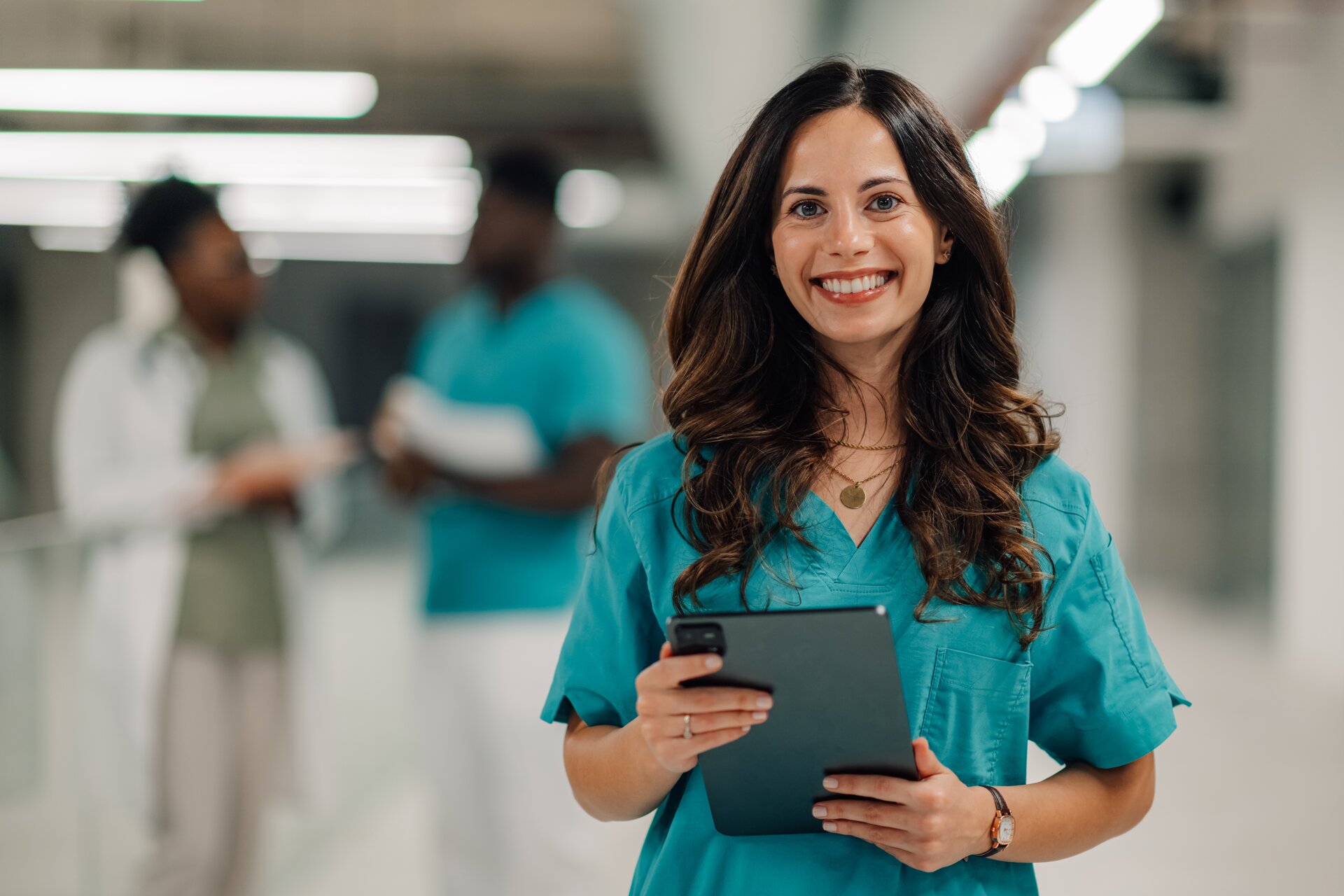 Healthcare professional with tablet reviewing operational reports and analytics