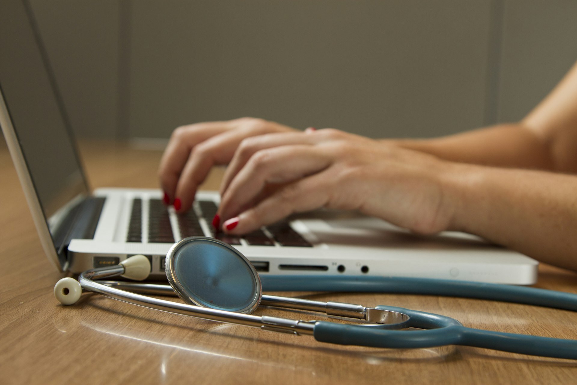 Healthcare professional providing bedside care to patient in long-term care rehabilitation facility