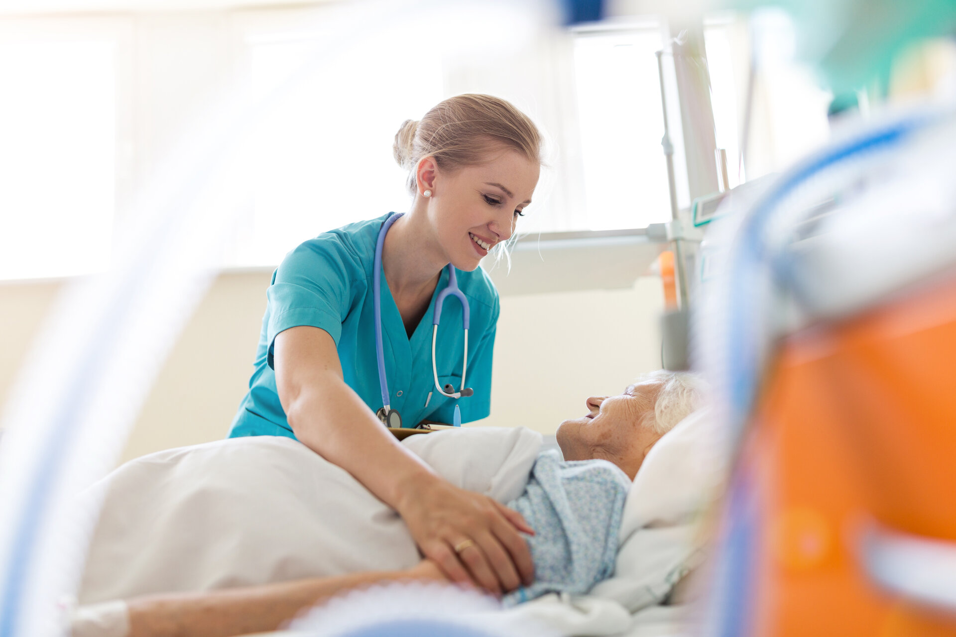 Nurse providing attentive bedside care to patient in skilled nursing facility